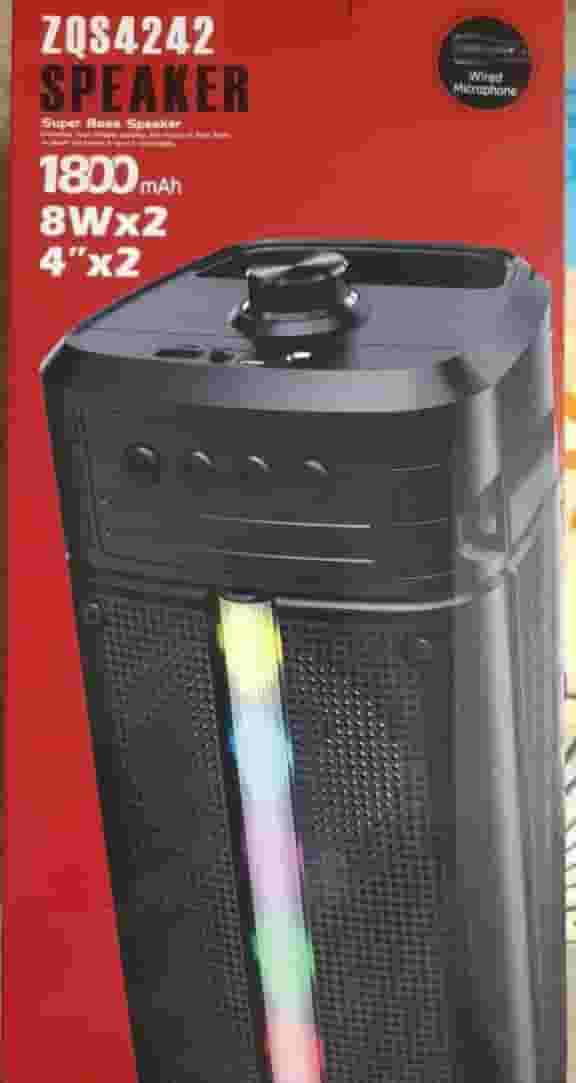 A large illuminated speaker with a mic